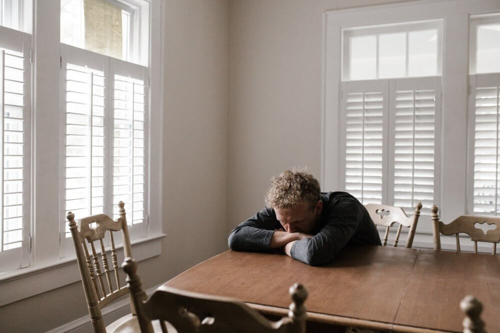 A sad man in a gray shirt