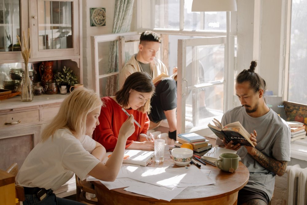 A group of people sitting at the table after hiring long-distance moving services