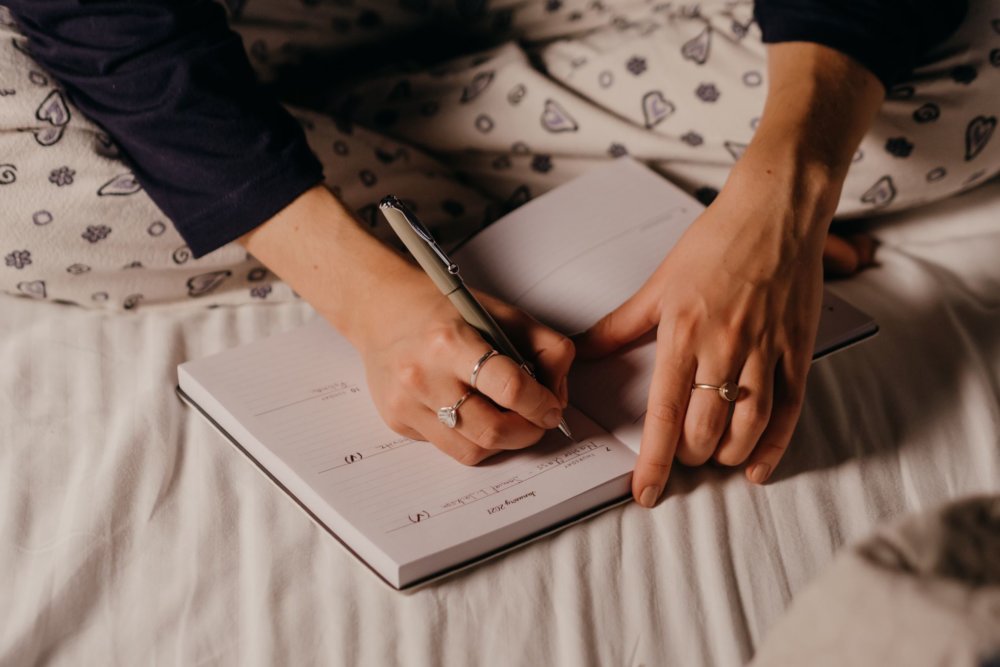 A woman writing tasks for long-distance movers