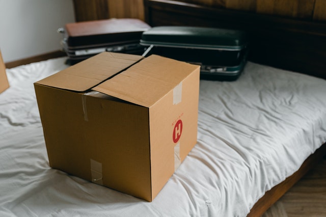 Box and suitcase on a bad prepared for long-distance moving