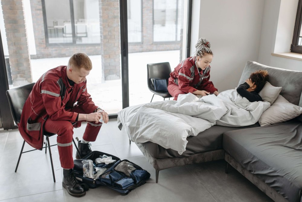 Ambulance workers medically treating a woman after a long-distance move