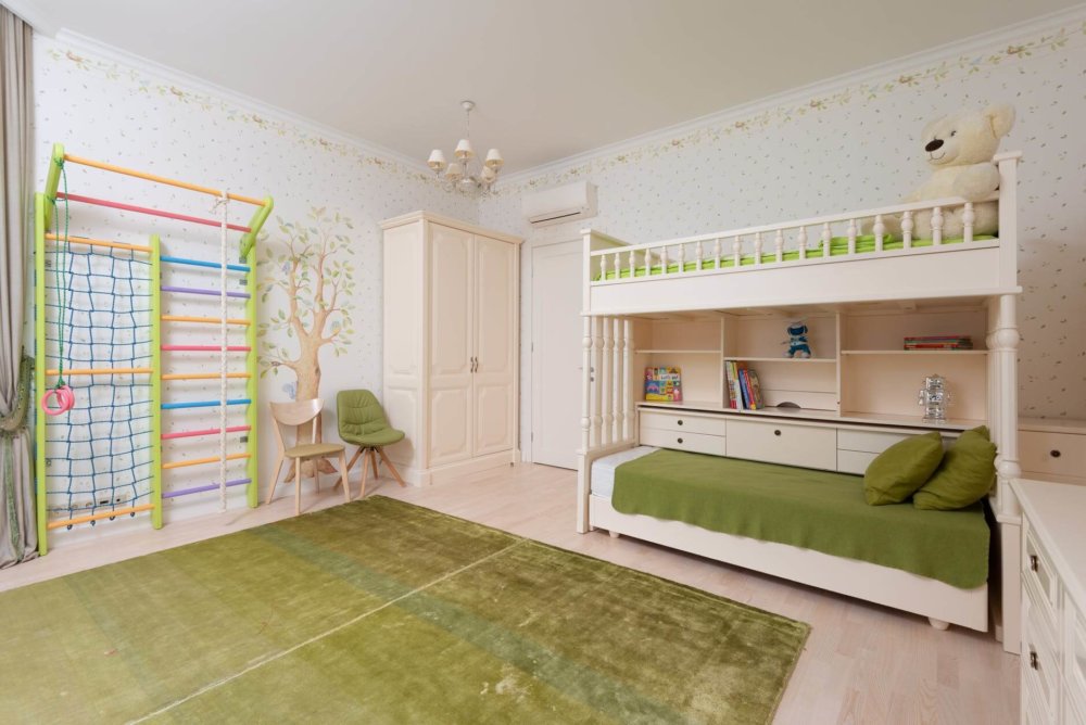 a colorful bunk bed in a room with a green rug