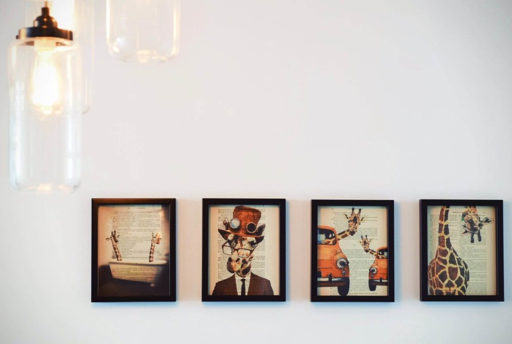 Four paintings hanging on the wall 