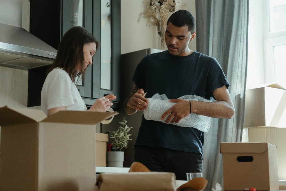 A man and a woman packing for cross-country moving