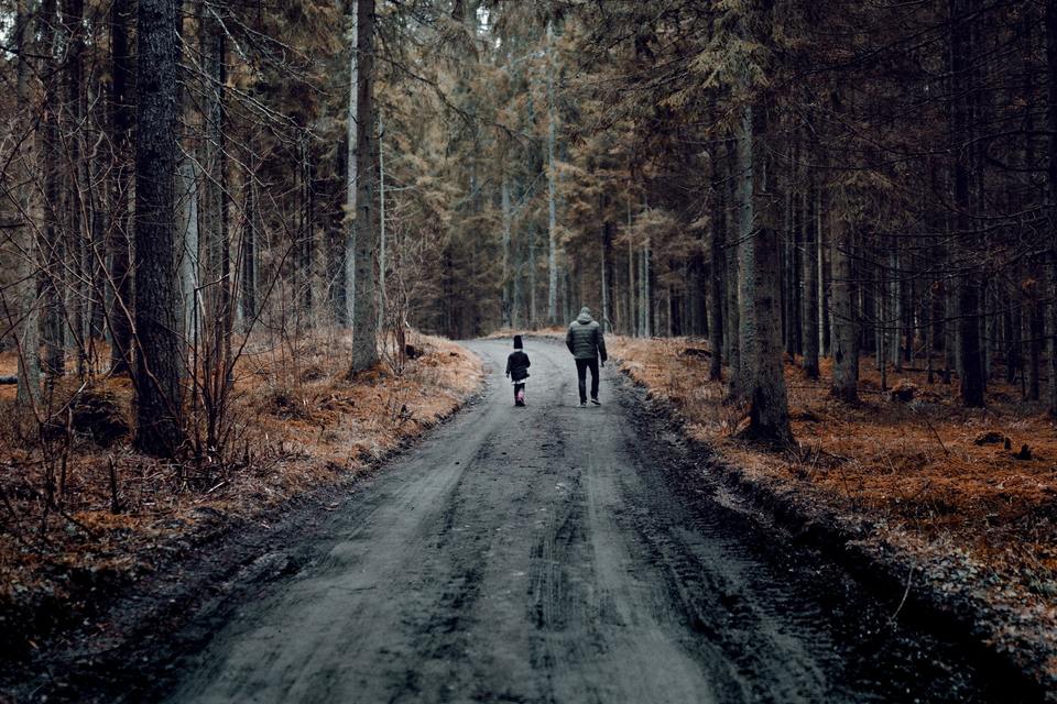 Two people walking in the forest after cross-country moving