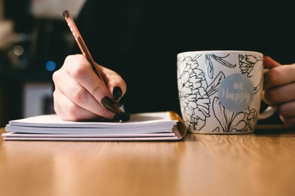 a woman writing a description for selling the house before long-distance 