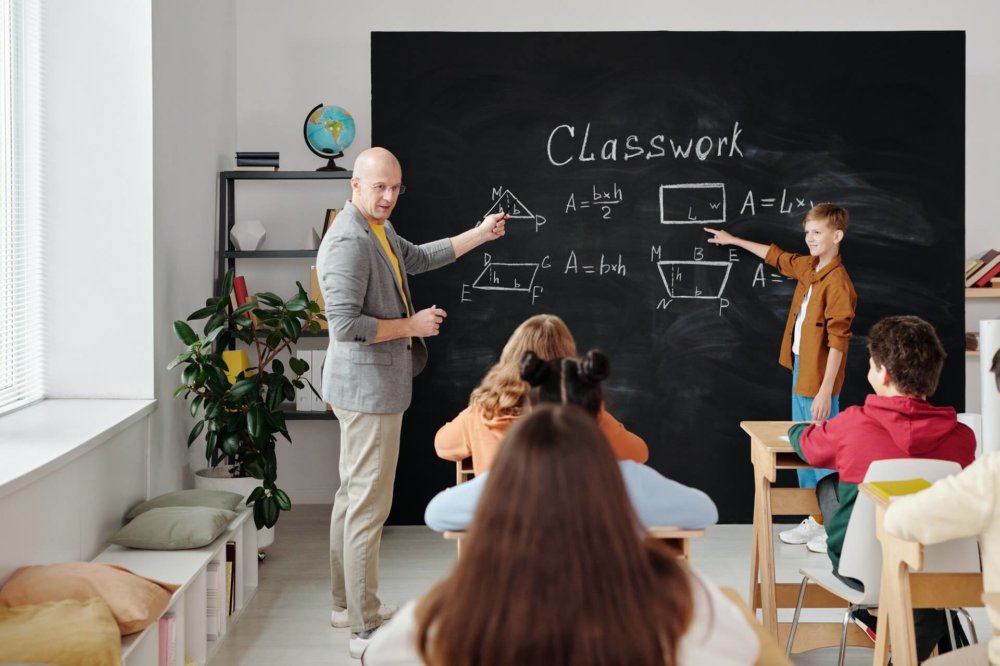 A teacher in front of kids