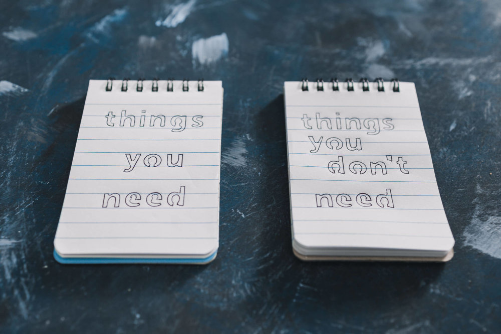 two small notepads with writing on them to help prepare for long-distance moving