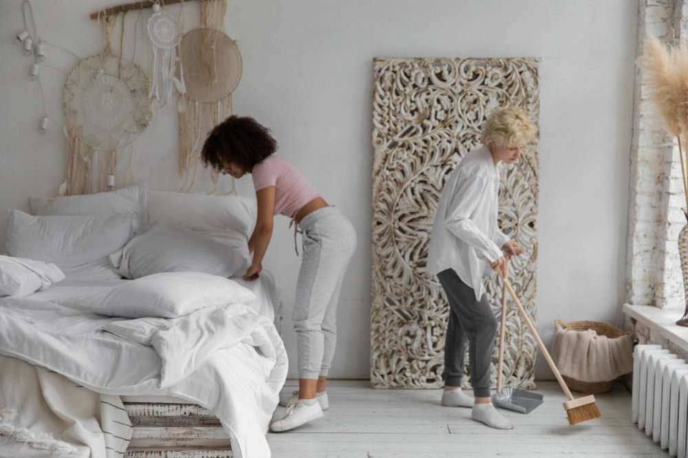 Women cleaning a bedroom