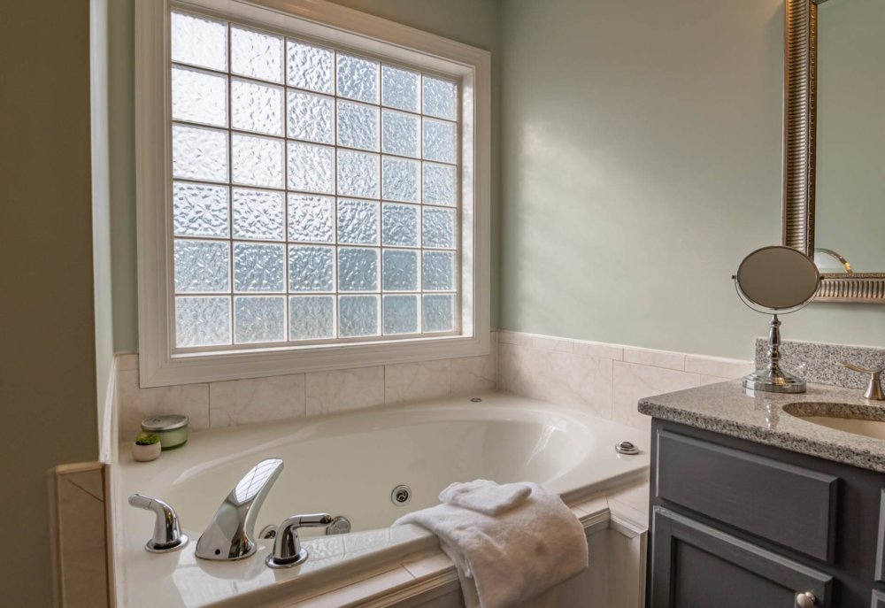 A bathroom with a ceramic bathtub 