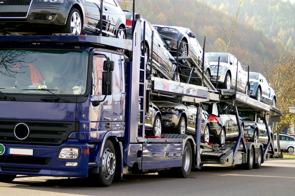 Auto transport company is transporting cars on an open trailer 