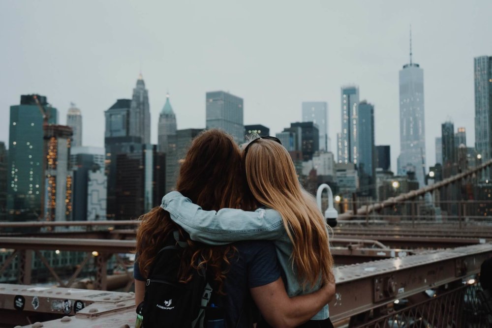 Two girls looking over the buildings