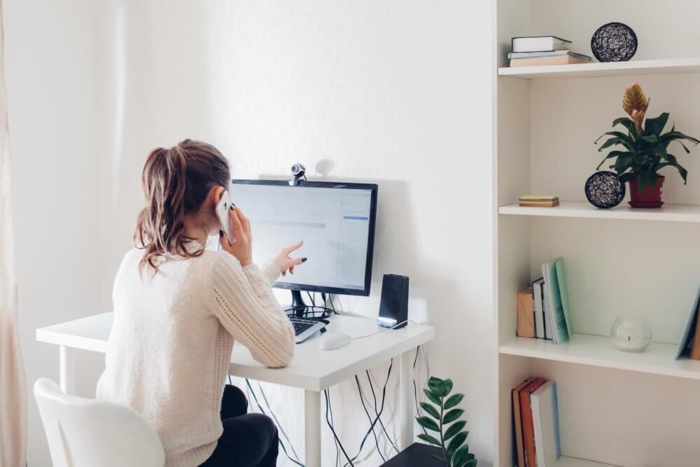 A woman searching for cross country movers on the internet