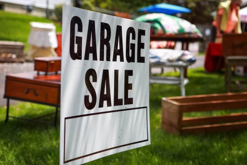 Big garage sale sign on a tree  