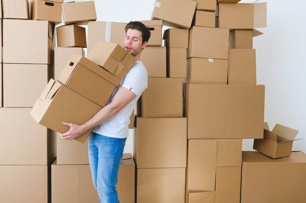 couple packing and looking at a picture frame