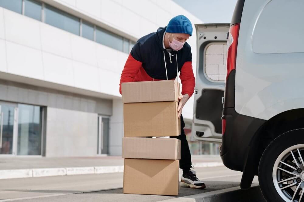 Professional mover handling boxes for long-distance moving