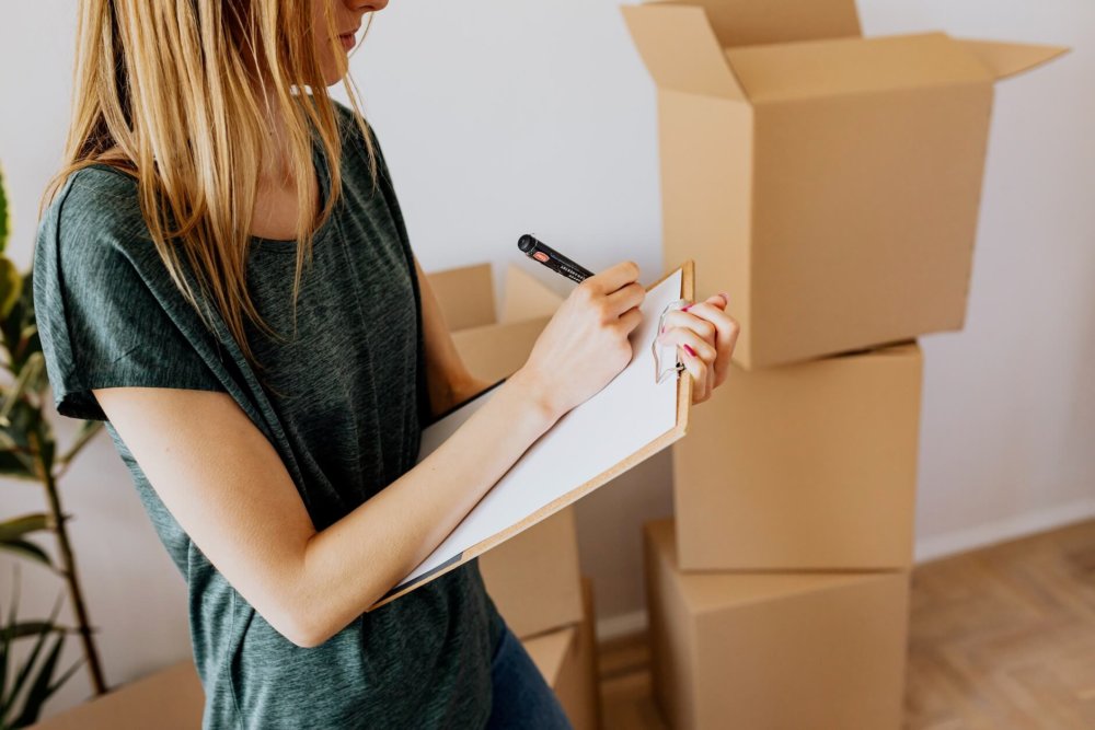 Woman making a home inventory before long-distance moving