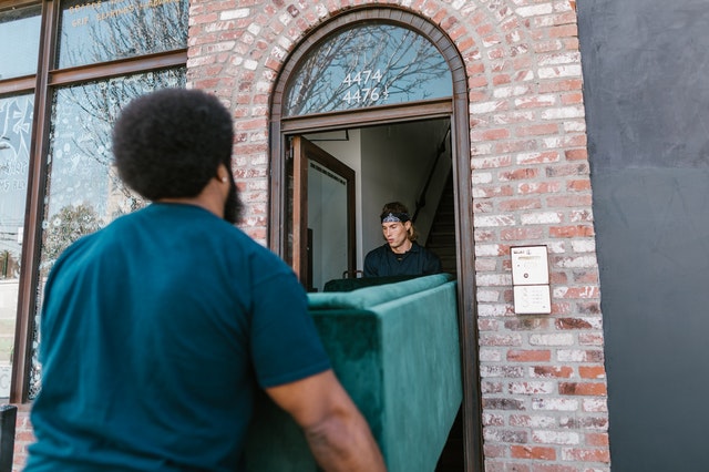 Cross-country movers carrying a couch 