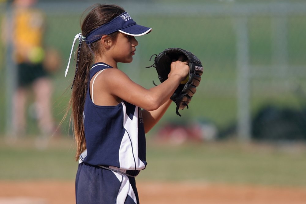 Girl playing baseball after long-distance moving