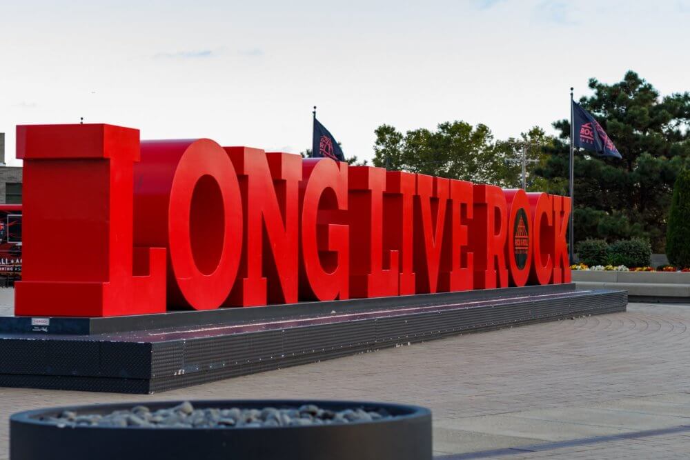 Sign in font of Rock & Roll Hall of Fame a person can visit after cross-country moving to Cleveland