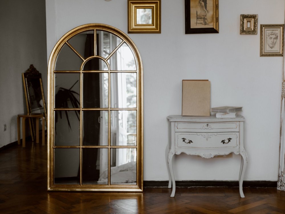 Vintage mirror on the wall next to a vintage table