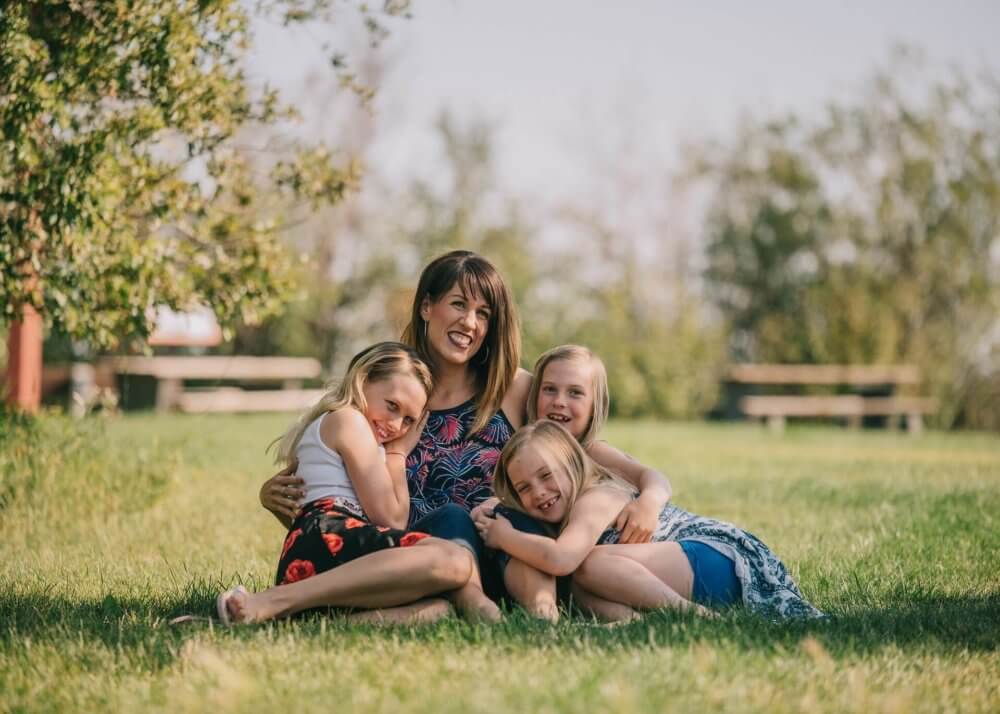 a family sitting on their lawn after moving cross-country