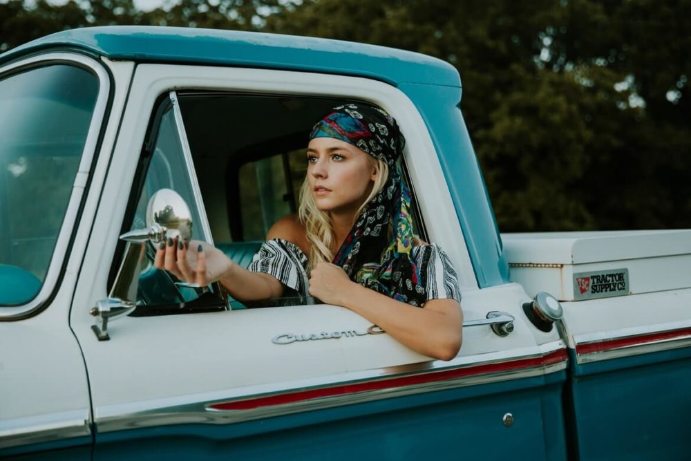 A girl in a pickup truck