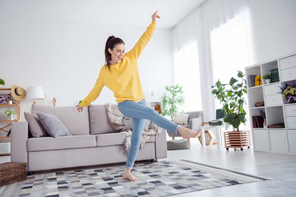 Full size portrait of overjoyed satisfied person dancing chilling living room house indoors