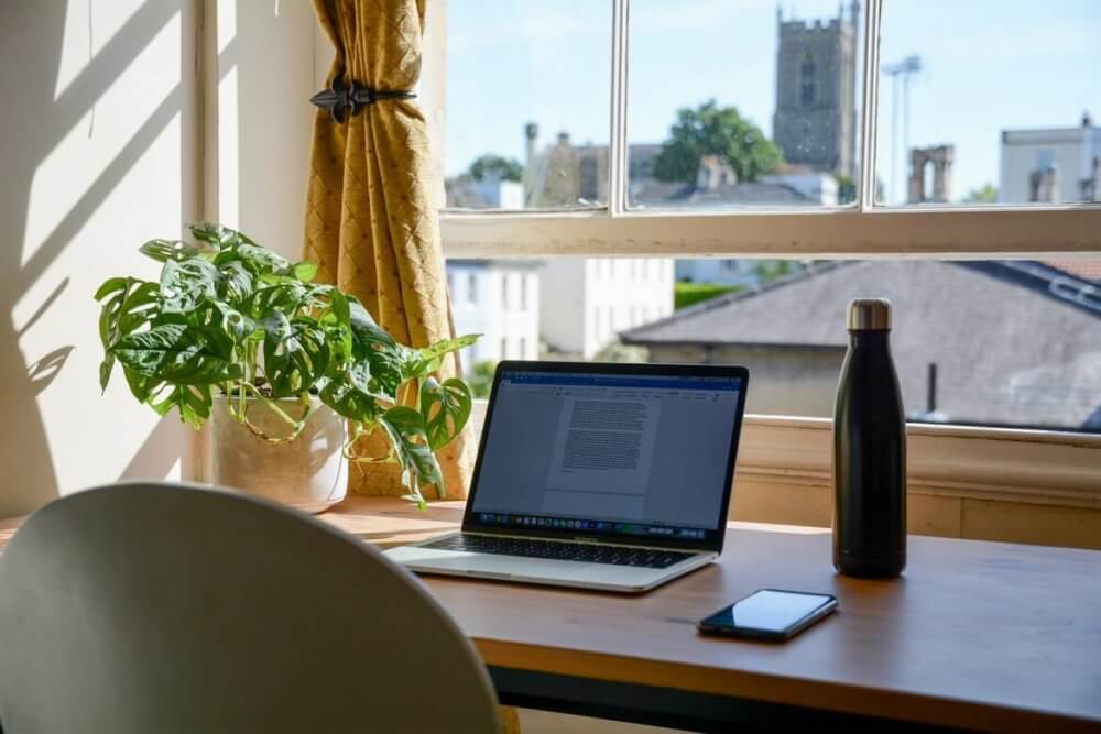 Laptop working area next to a window