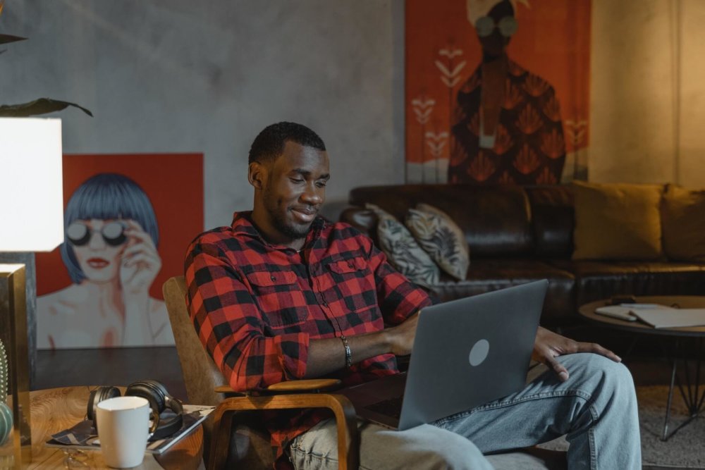 A man talking to his partner on the laptop and smiling