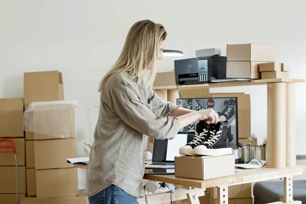 A woman preparing black shoes before long-distance moving