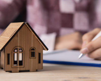 a young woman with a house, car and documents