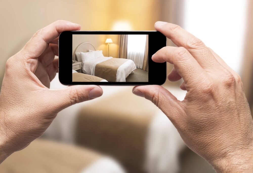 A man taking a photo of the furnishing he's going to sell