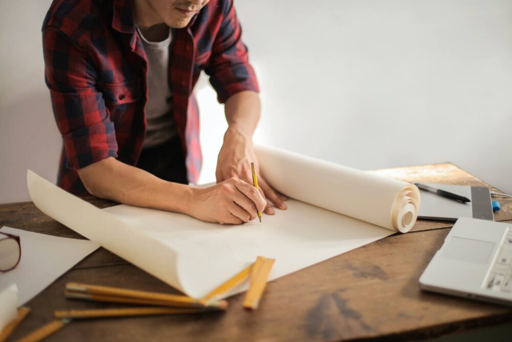 A man drawing a draft with a pencil 