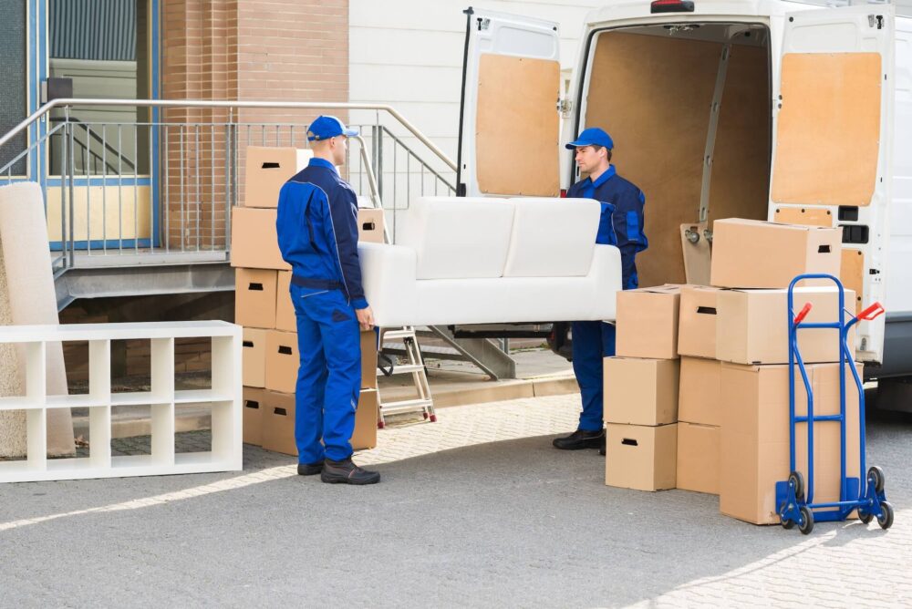 Two long-distance movers loading a couch