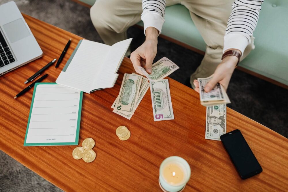 A person counting money on the table