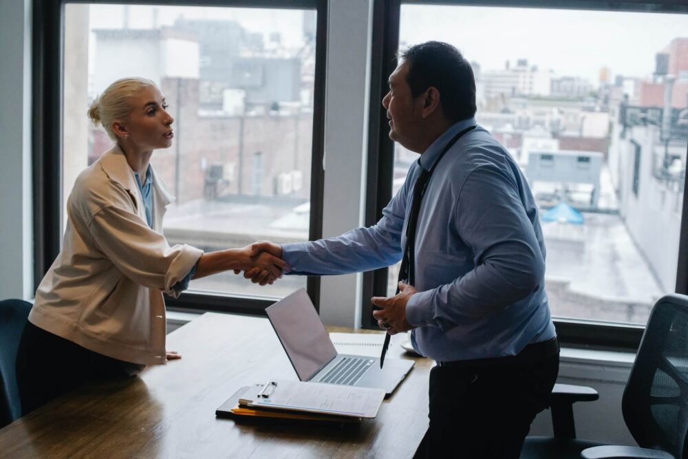 A man and a woman shaking hands 