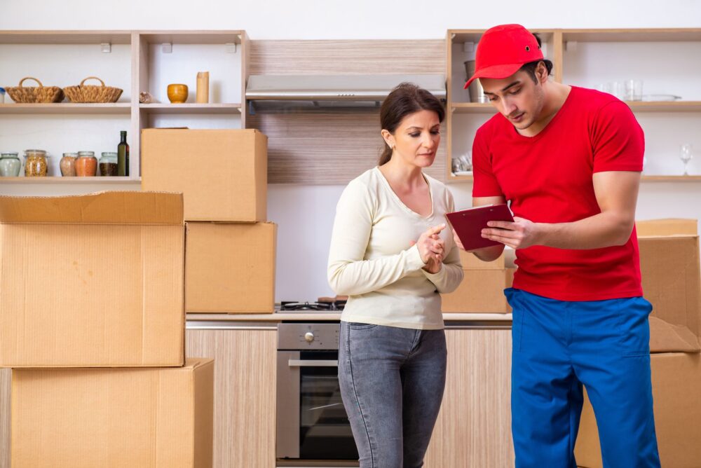 A woman and a mover looking at a list