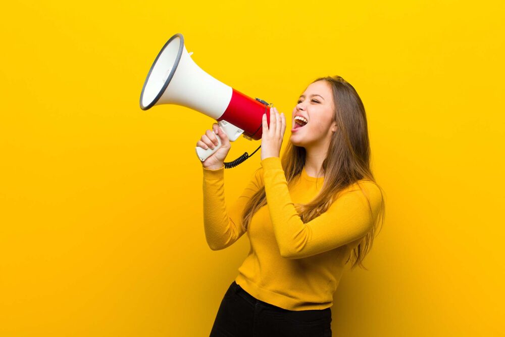  young pretty woman with a megaphone Flat Price Auto Transport and Moving logo