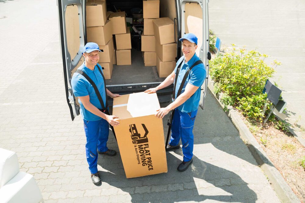 Cross-country movers holding a box