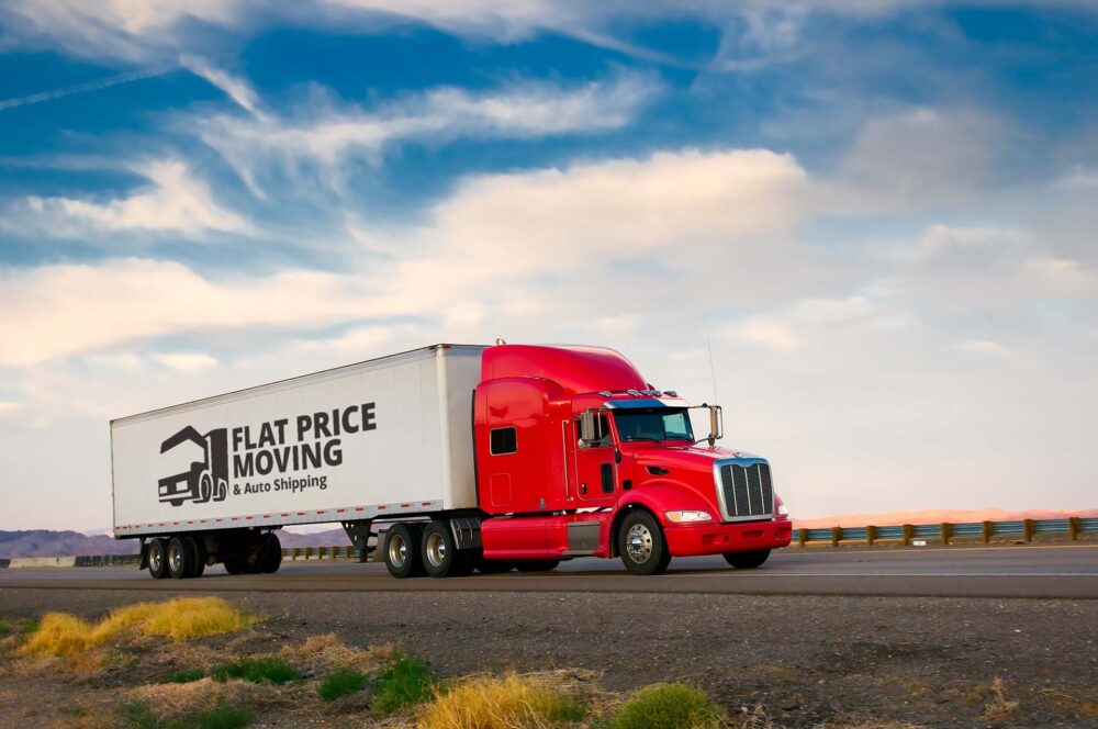 Relocation truck with a Flat Price Auto Transport and Moving logo 