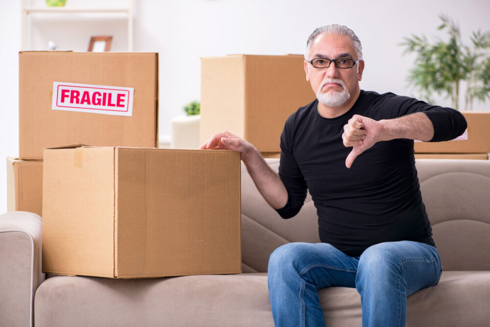 An older man dissatisfied with long-distance moving services