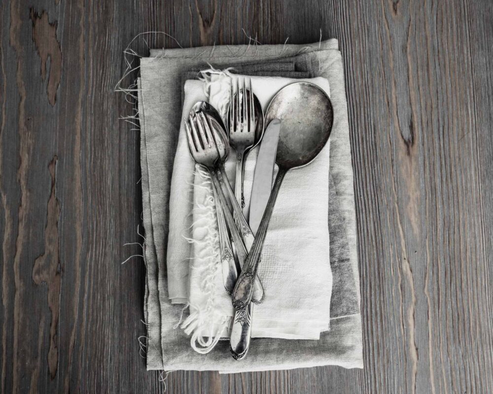 Silverware on a grey and white napkin