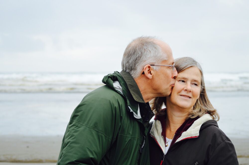 Elderly couple on the beach in winter