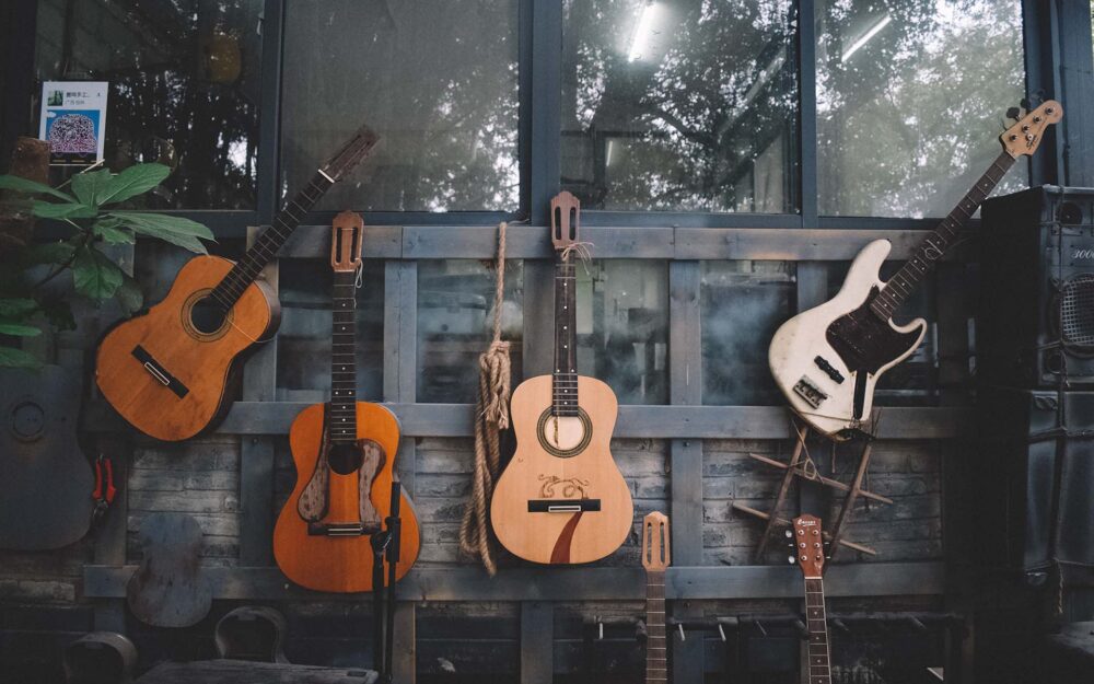 Different guitars mounted on a wall
