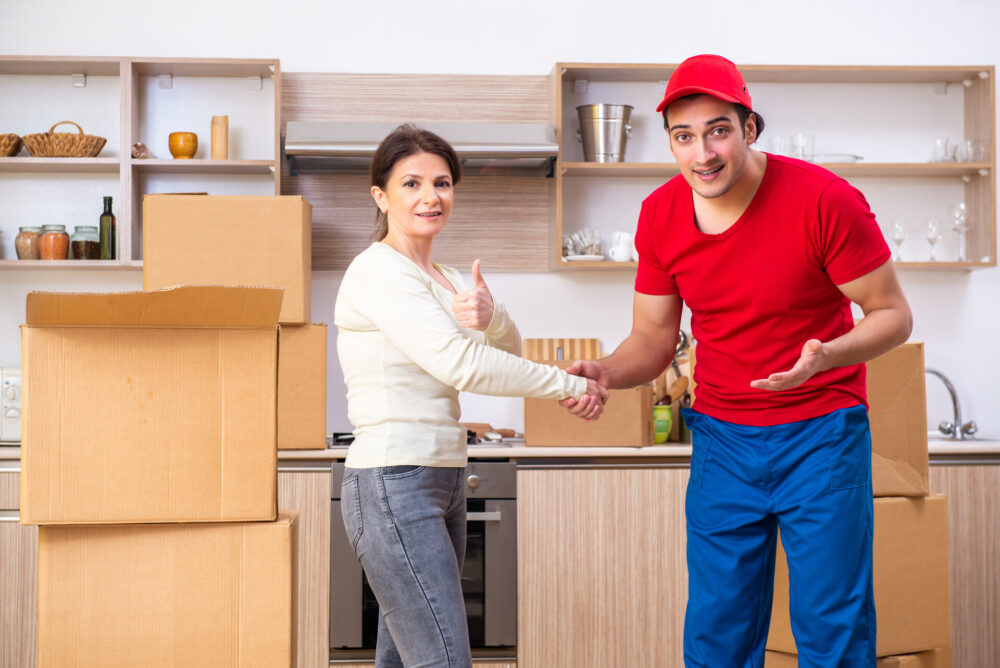 Woman shaking hands with mover in a kitchen