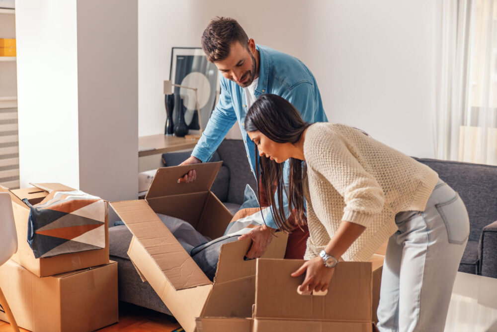 Man and woman carrying boxes