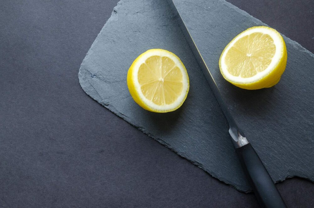 Sliced lemon next to a knife