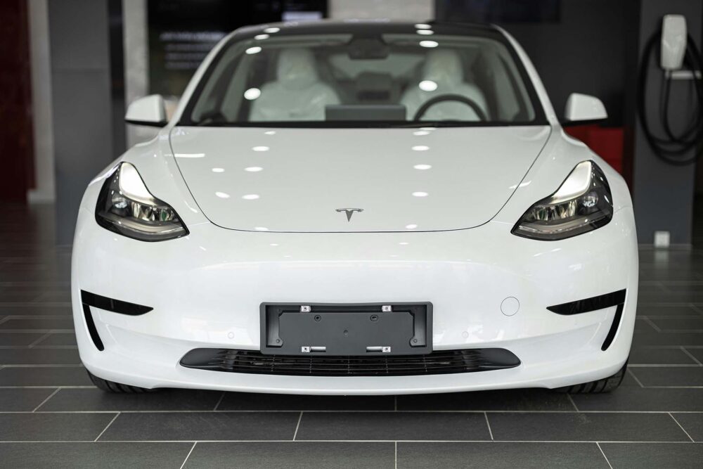 White Tesla vehicle on the gray floor