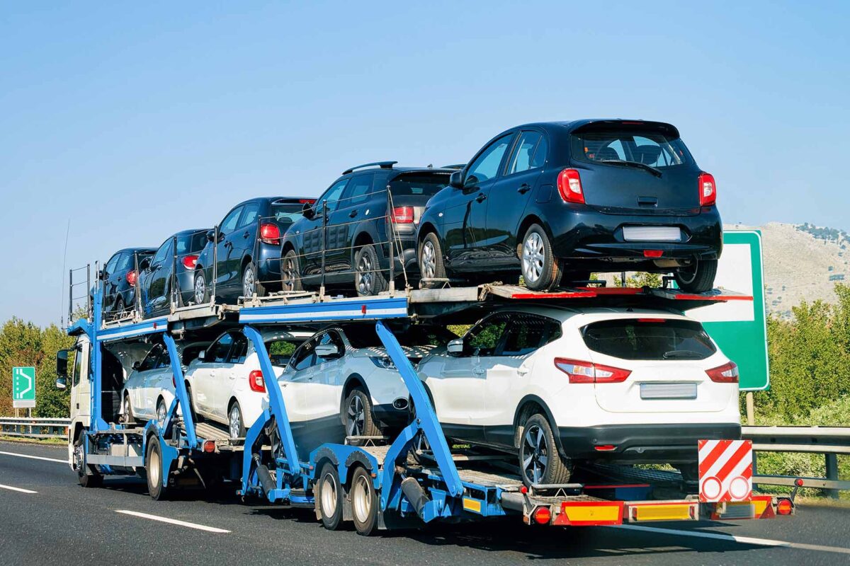 Cars carrier at the road. Truck transporter
